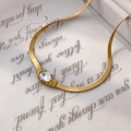 Close-up of a gold snake chain necklace featuring a sparkling round zircon stone - Snake Bone Wide Chain Zircon