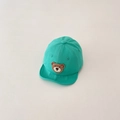 Detail view of mint green baby baseball cap featuring a cute knitted bear patch - Green