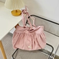 Detailed view of pink pleated canvas tote bag with Somakka label and decorative bow shoulder strap - Ramie Taro Purple