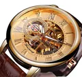 Macro shot of gold skeleton mechanical watch face with visible gears and Roman numerals - Brown Strap Brown Dial