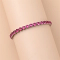 Close-up of pink round-cut tennis bracelet with silver-tone four-prong claw setting - 18cm / Rose Red