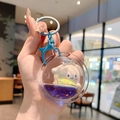 Cinnamoroll drijfzand sleutelhanger met blauwe glitters en een 3D-figuurtje - Klein-Cinnamoroll