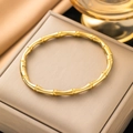 Detailed view of a golden bamboo-style titanium steel bangle on a luxury jewelry box - 【z4816】bamboo Joint Bracelet Gold