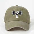 Detail view of washed cotton fabric and embroidered dumbbell graphic on an olive baseball cap - Dark Khaki