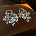 Silver leaf tassel hoop earrings with metallic wheat ear design on a wooden stand - Silver Leaf Tassel Ear Clip / Silver