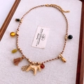 Detailed close-up of ethnic woven necklace with horse charm and colorful beads on tray - Necklace-Gold-Brown-Horse (WN1501)