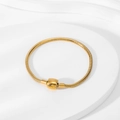 Macro shot of an 18K gold-plated snake bone chain bracelet with a smooth barrel clasp closure - Gold Drum Clasp
