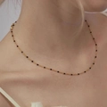 Minimalist gold necklace with black enamel beads shown on neck for a layered look - 50+5cm / Gold/Black Enamel
