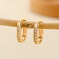 Detail view of champagne gold hoop earrings with zircon stones on wooden branch - EH212 Simple Single Row