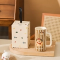 Ceramic puppy mug with brown stripes and matching gift box on a wooden tray - Dachshund Artist