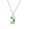 Macro shot of gold plated pendant with blue enamel face and zircon crystals inlay - Blue Face Pendant