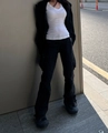 Women's casual white V-neck T-shirt paired with black cargo pants in outdoor street style - S / White