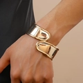 Close-up of minimalist golden irregular cross open cuff bracelet on a model's wrist - 128# Mirror Polished Overlapping Style / Gold