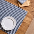 Blue and white striped linen table runner and matching napkin on a rustic wooden table - Blue Fine Stripe