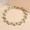 Detail of gold wave-link necklace with turquoise beads and sparkling crystals - Blue Round Necklace