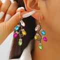 Close-up of dangling Christmas tree earrings with colorful rhinestones on a female model - 28 KC Gold 2449