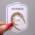 Elegant gold crescent moon brooch with micro-pave white crystals and pearl finish - Sparkling Crescent Moon