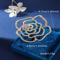 Golden flower-shaped pearl brooch with crystal rhinestones on blue velvet display - Xd825285