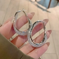 Macro detail of silver oval hoop earrings with sparkling crystal texture held by hand - Frosted Glitter Multi-Layer Hoop (E1827 Silver) / 925 Silver Needle / Silver