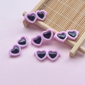 Macro shot of small pink heart-shaped resin sunglasses accessories on a bamboo tray - 28*12mm / Purple