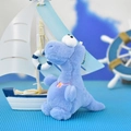 Detail view of a cute blue plush dinosaur keychain with a quirky tilted head - 14cm / Blue