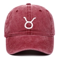 Close-up of Taurus zodiac embroidery on washed red cotton baseball cap detail - Burgundy