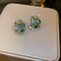 Close-up of luxury gold butterfly earrings with blue and green gems and sparkling zircons - Gold Crystal Oval (24#)