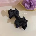 Detail showing two black satin bow hair clips with 5.3cm measurement for styling - Single Piece / Black
