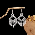 Detailed close-up of bohemian antique silver earrings with leaf tassel charms on a branch - E2875-43/Geometric Rhombus
