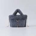 Chic grey faux fur handbag with golden deer emblem and fringe tassel detail - Smoke