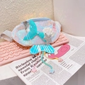 Detail of sequin mermaid fanny pack for kids with colorful tassels and starfish charms - White