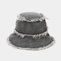 Close-up of distressed edges and frayed fringe detail on dark grey denim bucket hat - One Size / Black