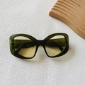 Green translucent cat-eye sunglasses with yellow amber lenses and a retro butterfly frame - Transparent Green