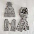 Detail of grey cable knit set including pompom beanie, scarf and gloves for winter - Gray