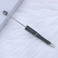 Deep grey matte DIY beaded pen featuring a metallic silver rod on white faux fur background - Glazed Grey