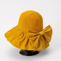 Detail of yellow sun hat featuring knit crown, wide fabric brim and large bow decoration - M (56-58cm) / Yellow
