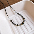 Macro detail of 18K gold-plated beaded necklace with black beads and natural spot texture - Spotted Beaded With Gold Spacer Style (15#)