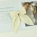 Beige plaid ribbon bow hair clip displayed on an elegant wedding invitation card - Off White