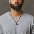 Men's hip hop black Om pendant necklace with stainless steel chain on grey shirt - Om Symbol / Black