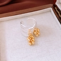 Detailed macro view of gold-plated irregular pleated ring in a wooden gift box - Irregular Fold Tassel Style / Gold and Silver Contrast