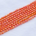 Dettaglio macro di perline a goccia arancioni con finitura iridescente AB - 4*5mm (circa 95pz/filo) / Rosso Arancio AB