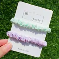 Lot de deux chouchous élastiques en vert menthe et lilas avec des pois orange - 2 pièces Style Aléatoire