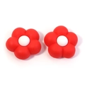 Detailed view of two 3D red flower PVC charms with white centers for beach bags - Red Flower White Center