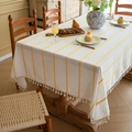 White Nordic tablecloth with yellow stripes and tassel fringe on a wooden dining table - 140-260 / Yellow & White Stripes