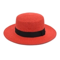 Detail view of red boater straw hat with black ribbon and woven texture - Red