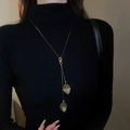 Minimalist adjustable golden leaf tassel necklace worn on a black turtleneck sweater - Gold Hollow Leaf Style (47#)