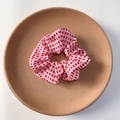 Cute red and white gingham scrunchie for women presented on a minimalist clay plate - Bright Red Plaid