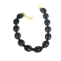 Detail of black coffee bean link chain bracelet with a gold lobster clasp and extension - Black