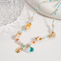 Detail of seashell necklace with pearls, beads and tassel on white surface - Green Conch Beaded Set (项链-绿色海螺)