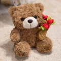 Brown plush teddy bear sitting on a beige carpet holding a red velvet flower bouquet - Brown Bouquet Bear
